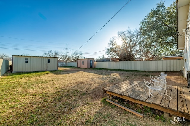 view of yard with a shed and a wooden deck