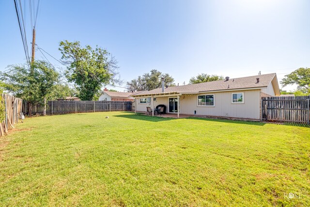 213 Amistad Rd, San Angelo, TX 76901 - fenced backyard with a patio