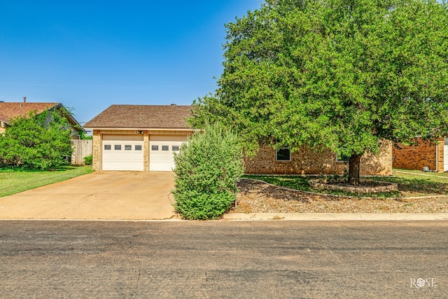 213 Amistad Rd, San Angelo, TX 76901 - view of front of property featuring brick siding, concrete driveway, and an attached garage
