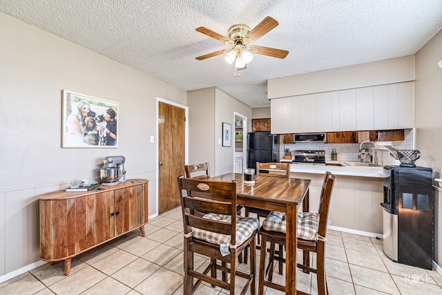 213 Amistad Rd, San Angelo, TX 76901 - dining room featuring light tile patterned floors, a ceiling fan, and a textured ceiling