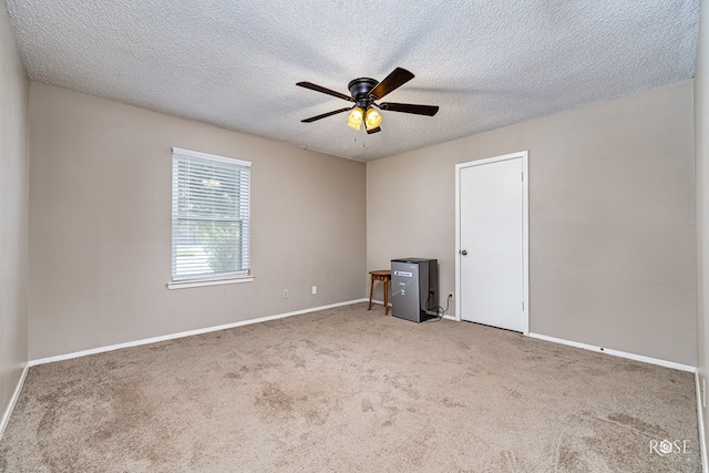 213 Amistad Rd, San Angelo, TX 76901 - spare room featuring carpet flooring, ceiling fan, and a textured ceiling