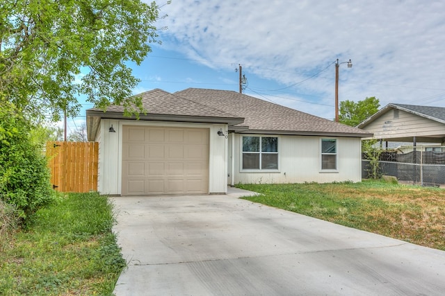 ranch-style home with concrete driveway, an attached garage, fence, and a shingled roof