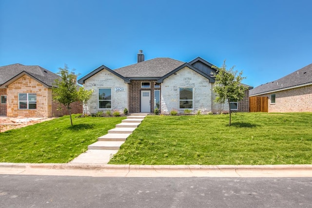 3609 Clearview Dr, San Angelo, TX 76904 - view of front facade featuring a front yard, a chimney, and a shingled roof