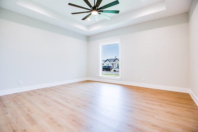 3609 Clearview Dr, San Angelo, TX 76904 - empty room with a tray ceiling, light wood finished floors, a ceiling fan, and recessed lighting