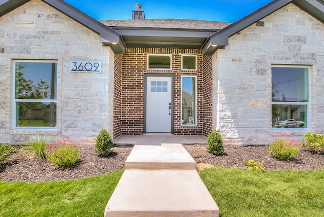 3609 Clearview Dr, San Angelo, TX 76904 - view of exterior entry with stone siding, brick siding, and a chimney