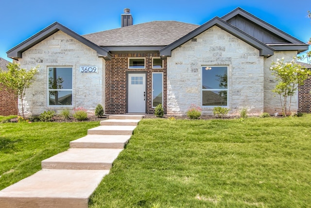 3609 Clearview Dr, San Angelo, TX 76904 - view of front of property with stone siding, a front yard, board and batten siding, and a chimney