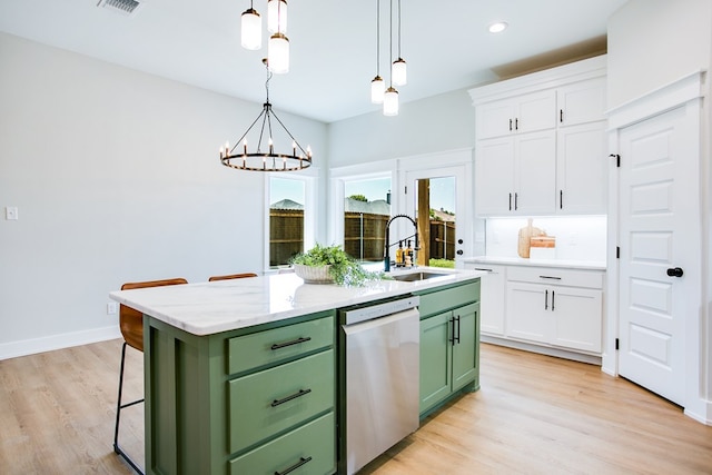 3609 Clearview Dr, San Angelo, TX 76904 - kitchen featuring green cabinets, dishwasher, white cabinetry, a center island with sink, and light wood-style floors