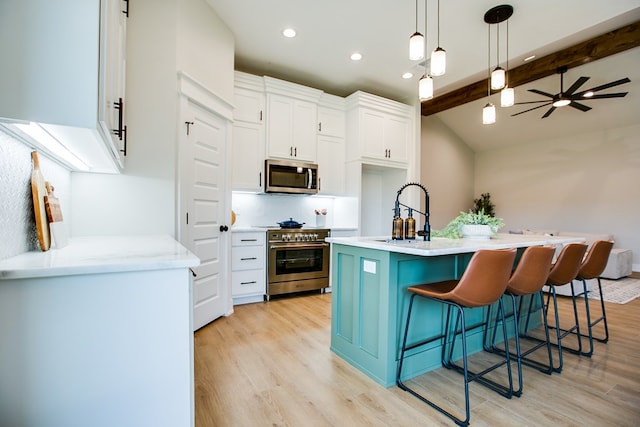 3609 Clearview Dr, San Angelo, TX 76904 - kitchen featuring appliances with stainless steel finishes, light wood-style floors, white cabinets, light countertops, and recessed lighting