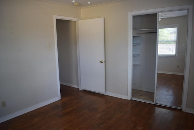 unfurnished bedroom featuring dark hardwood / wood-style flooring and a closet