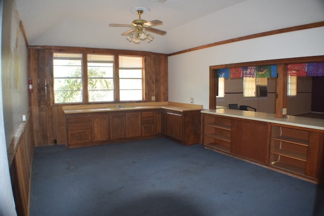 kitchen featuring dark colored carpet, vaulted ceiling, and ceiling fan