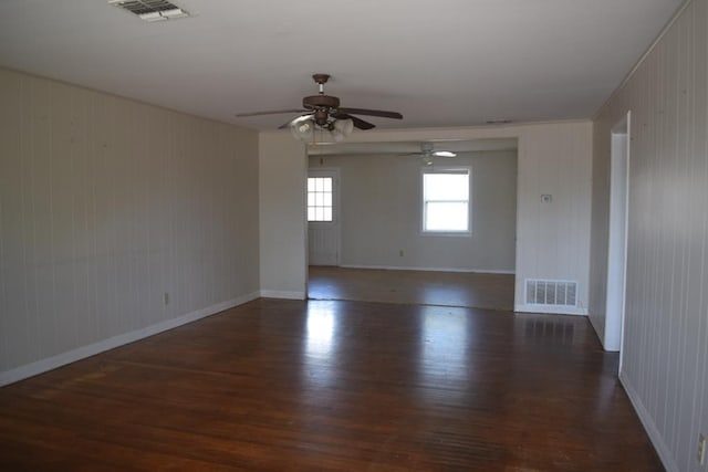 spare room featuring dark wood-type flooring and ceiling fan