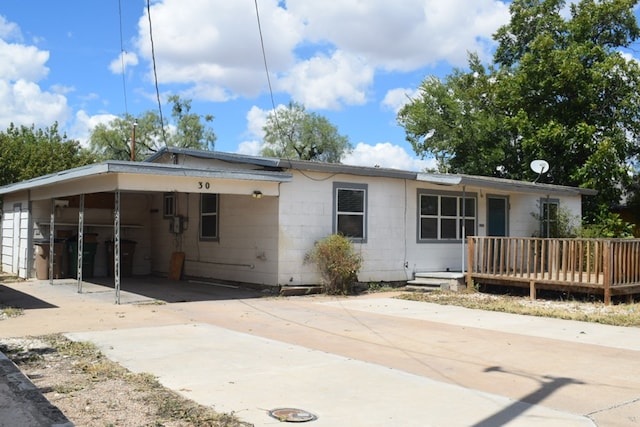 back of house with a carport