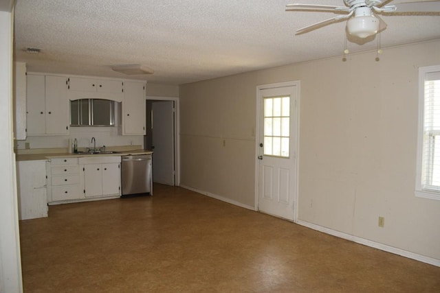 kitchen with white cabinetry, sink, stainless steel dishwasher, and a textured ceiling