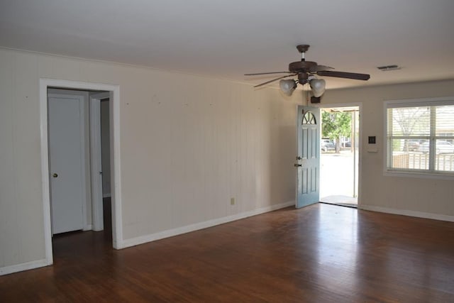 spare room featuring dark hardwood / wood-style floors and ceiling fan