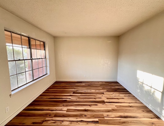 2726 Erline Dr, San Angelo, TX 76901 - unfurnished room featuring wood finished floors, a textured ceiling, and baseboards