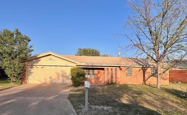 2726 Erline Dr, San Angelo, TX 76901 - ranch-style house with a garage, driveway, metal roof, brick siding, and a front yard