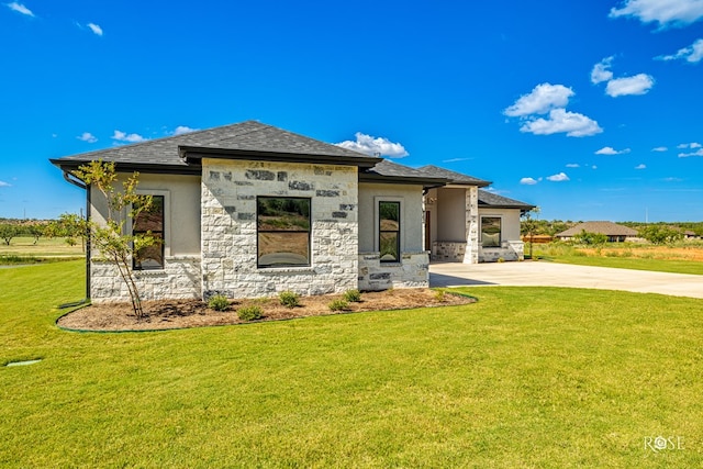 2301 Hillside Dr, San Angelo, TX 76904 - view of front of home featuring a front lawn, concrete driveway, stone siding, a shingled roof, and stucco siding