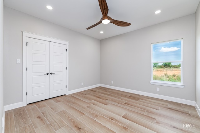 2301 Hillside Dr, San Angelo, TX 76904 - unfurnished bedroom featuring light wood finished floors, baseboards, recessed lighting, a closet, and a ceiling fan