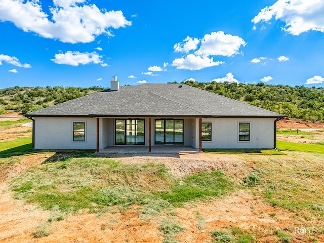 2301 Hillside Dr, San Angelo, TX 76904 - rear view of house featuring a chimney, a patio area, a yard, and stucco siding