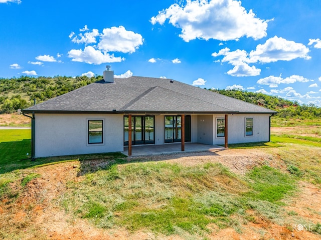 2301 Hillside Dr, San Angelo, TX 76904 - rear view of property with a patio area, a chimney, a yard, and stucco siding
