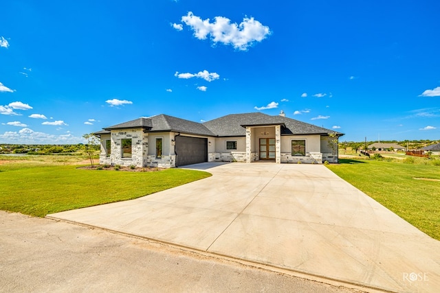 2301 Hillside Dr, San Angelo, TX 76904 - prairie-style house with a garage, concrete driveway, stucco siding, stone siding, and a front yard