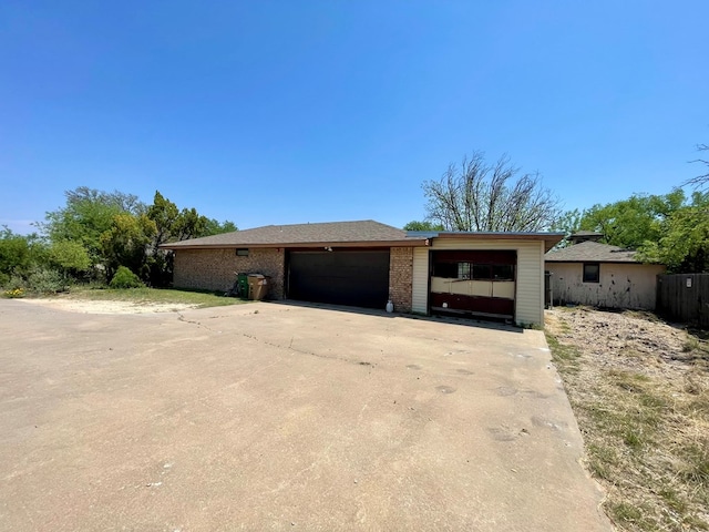 165 Edinburgh Rd, San Angelo, TX 76901 - view of front of house featuring an attached garage, driveway, and brick siding
