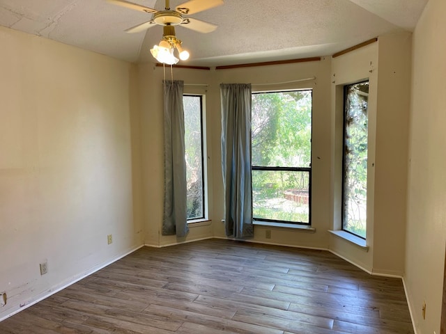 165 Edinburgh Rd, San Angelo, TX 76901 - empty room featuring a healthy amount of sunlight, wood finished floors, ceiling fan, and baseboards