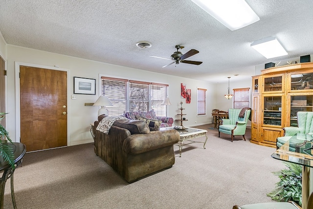 carpeted living room featuring a textured ceiling and ceiling fan