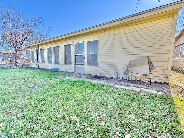 rear view of house featuring a yard