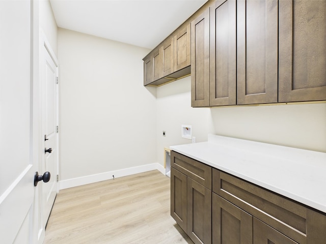 1942 Pine Valley St, San Angelo, TX 76904 - washroom with hookup for an electric dryer, cabinet space, light wood-style flooring, and washer hookup