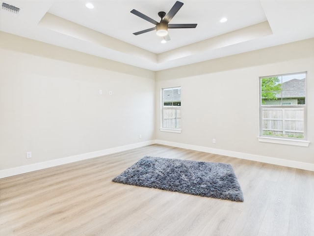 1942 Pine Valley St, San Angelo, TX 76904 - spare room with a raised ceiling, healthy amount of natural light, light wood-style floors, ceiling fan, and recessed lighting