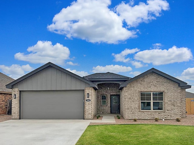 1942 Pine Valley St, San Angelo, TX 76904 - single story home with driveway, an attached garage, brick siding, and board and batten siding