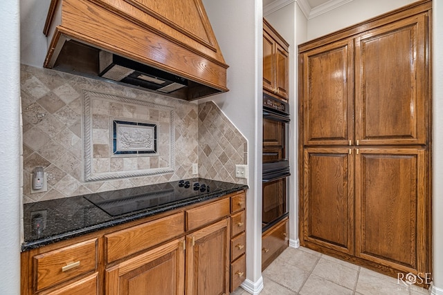 2141 Valleyview Dr, San Angelo, TX 76904 - kitchen featuring black appliances, custom range hood, decorative backsplash, brown cabinets, and ornamental molding