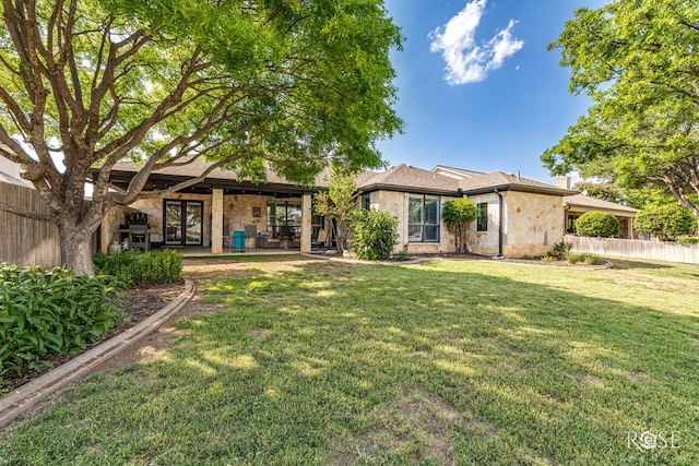 2141 Valleyview Dr, San Angelo, TX 76904 - rear view of house featuring stone siding, a chimney, and french doors