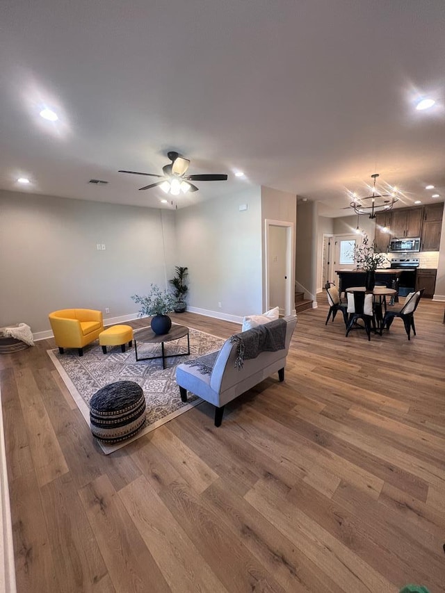 living room with hardwood / wood-style flooring and ceiling fan