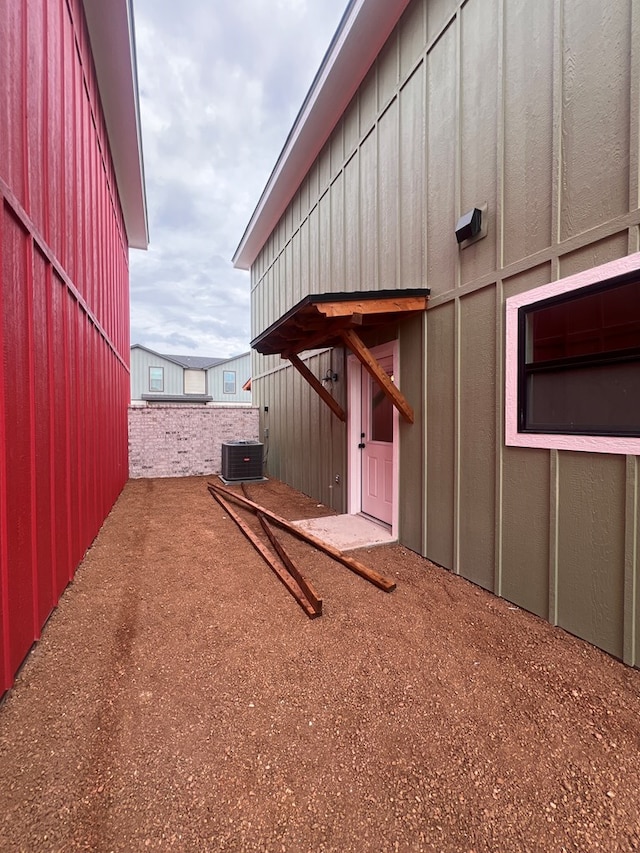 view of side of home featuring central AC