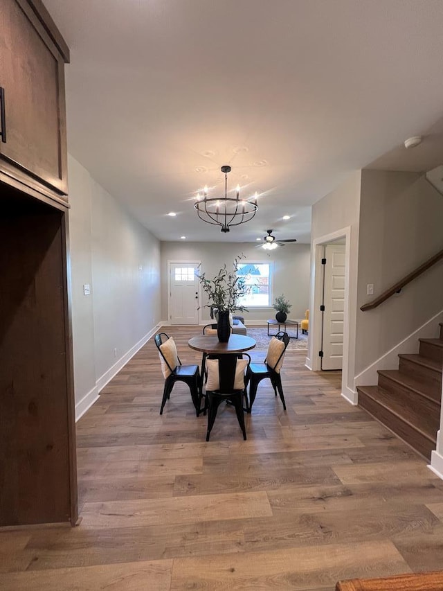 dining room with wood-type flooring and a chandelier