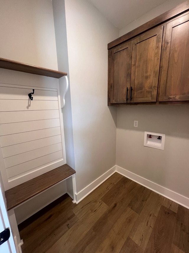 laundry area with dark wood-type flooring, cabinets, and hookup for a washing machine