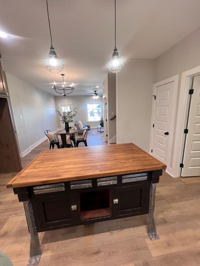 dining space with an inviting chandelier and light hardwood / wood-style flooring