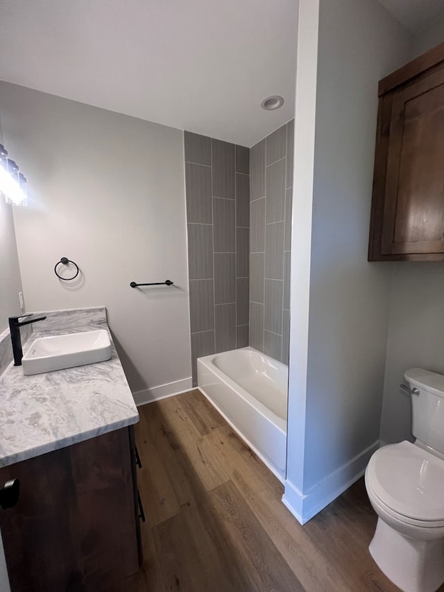 full bathroom with vanity, toilet, shower / bath combination, and wood-type flooring