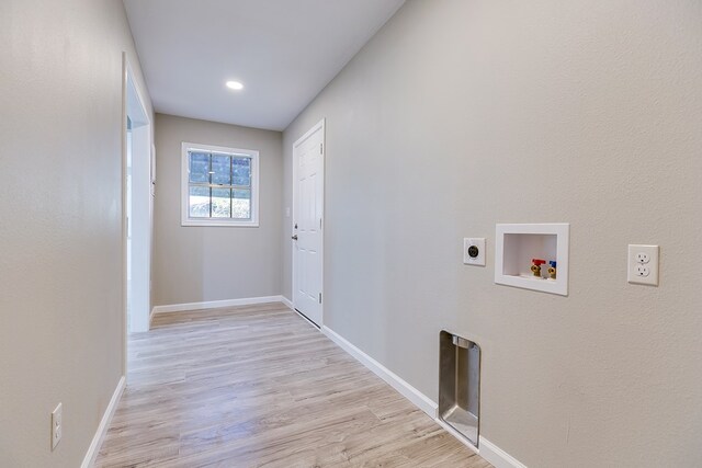 washroom with hookup for a washing machine, electric dryer hookup, and light hardwood / wood-style flooring