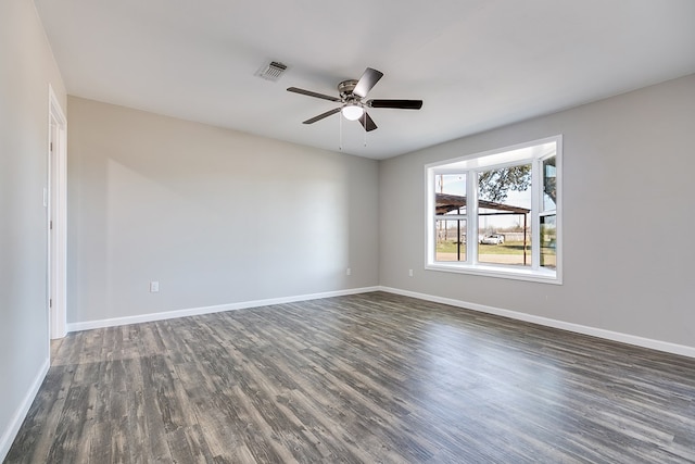 empty room with ceiling fan and dark hardwood / wood-style flooring