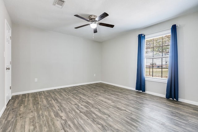 spare room featuring ceiling fan and dark hardwood / wood-style flooring