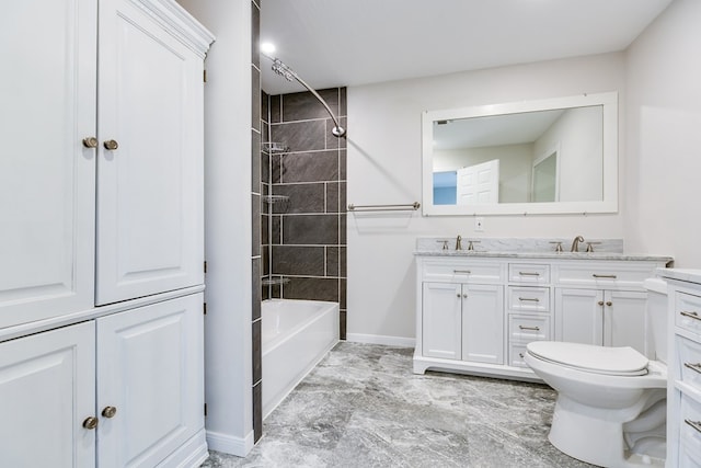 full bathroom featuring vanity, toilet, and tiled shower / bath