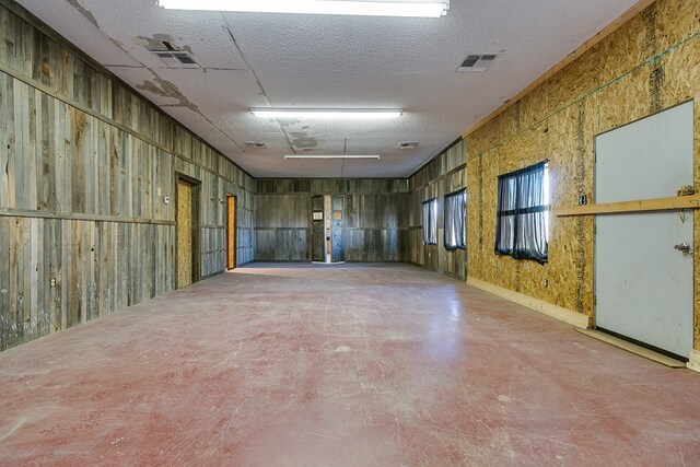 unfurnished room featuring a textured ceiling