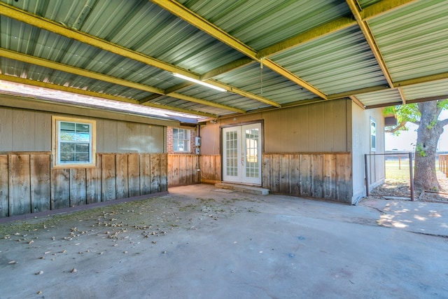 misc room featuring concrete flooring and french doors