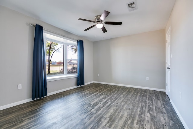 empty room with dark hardwood / wood-style floors and ceiling fan