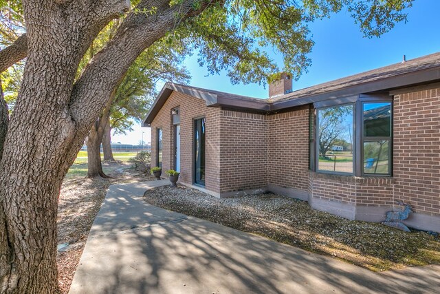 view of property exterior with a patio