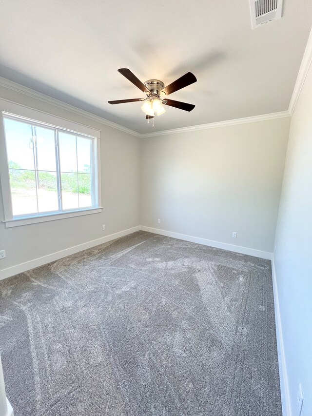 carpeted empty room featuring ornamental molding and ceiling fan