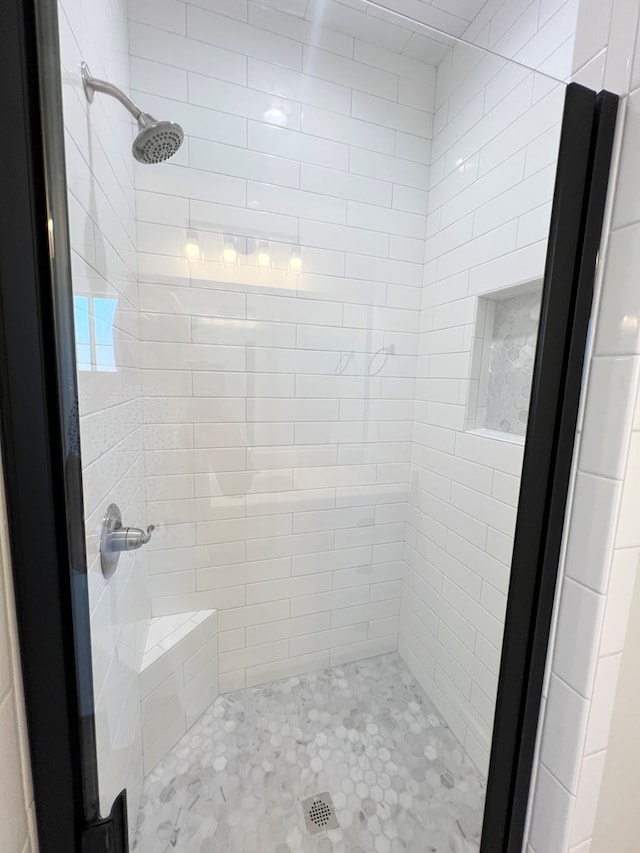 bathroom with a tile shower